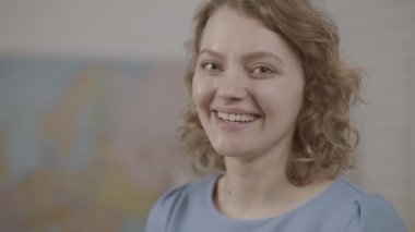 Öğretmen 'in sınıfta çekilmiş portresi. Gülen kız öğrenci ya da kadın öğretmen portresi duvardaki tahtada..