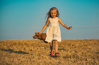 Sevimli çocuk eğleniyor. Şirin bir genç kız. Küçük çocuk temiz havada eğleniyor. Çocuk yaz neşesine sahip. Mutlu bir çocukluk. Küçük kız yürümekten hoşlanıyor. Mutlu küçük çocuk gülümsüyor.