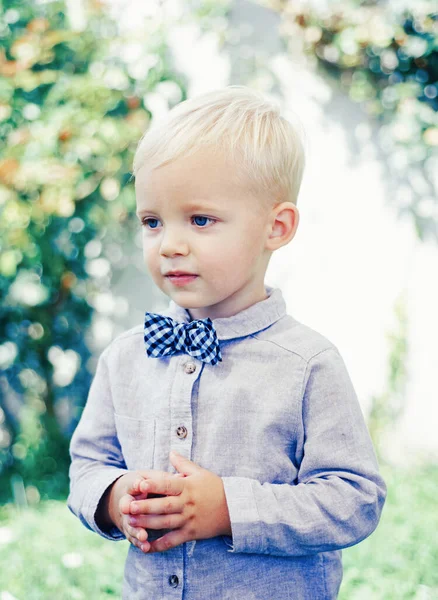 Beautiful fun day for cute little boy in nature. In suit and bowtie. Happy childhood. Little child enjoy walk. — Stock Photo, Image