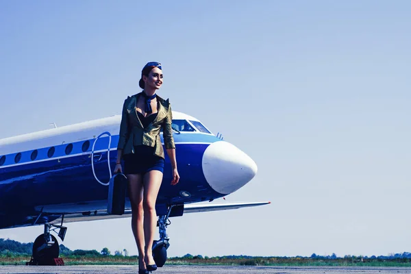 Charming stewardess dressed in blue uniform. Beautiful stewardess. Traveling and jet plane flying concept. Journey and jet trip. Air stewardess. Flying attendants air hostess.