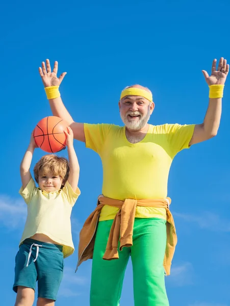 Grandfather and grandson, sports education. Motivation and sport concept. Body care and healthcare. Outdoor activities and healthy lifestyle. Preparing for morning workout in the park.