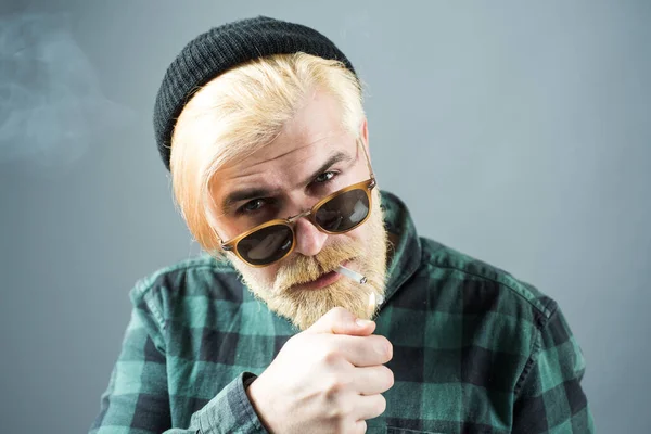 Man smoking. Close up face of a young man without emotions. Portrait Handsome Business man with confident face. — Stockfoto