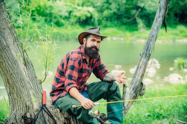 Man fisherman catches a fish. Gone fishing. Hunting. Fisherman show fishing technique use rod. Real happiness. Luxury life concept. Fishing is fun. Trout bait. Summer weekend. Giving your hobby.
