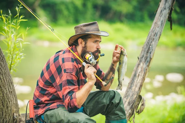 Nice day for fishing. Happy fisherman. Fisher fishing equipment. Young man fishing. Legend has retired. Portrait man on holiday. Fisher have long rod. — Stock Photo, Image