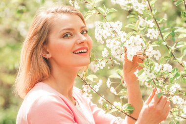 Womens day, 8 march. Happy Woman with Blossom tree over nature background.