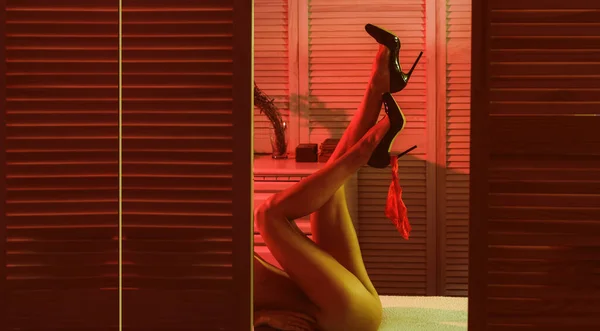 Sexy Frauenbeine in schwarzen High Heels mit Spitzenhöschen. Frauenpower und Dominanz. nackte Frau mit langen schönen Beinen liegen auf dem Bett. erotisches Verlangen. — Stockfoto