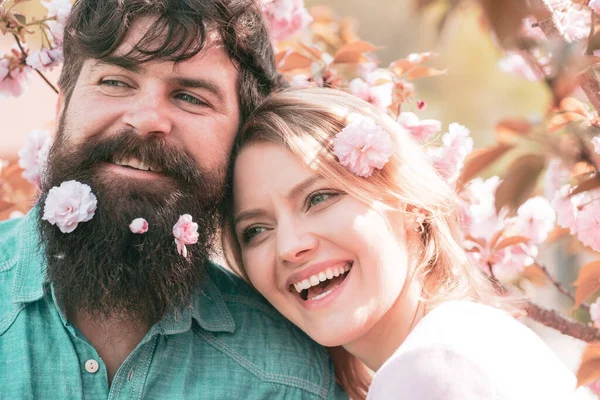 Man and woman in blooming garden. Couple spend time in spring blossoming tree garden. Couple enjoying a moment in blossoming garden. — 图库照片