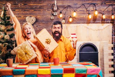 Excited funny Christmas couple with gift box. Wish you merry christmas. New year. New year gift box, christmas decoration. Merry christmas. Xmas background.