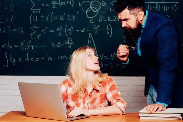 Tutor helping his student. Students campus education knowledge concept. Teacher and student sit together at education class. — 스톡 사진