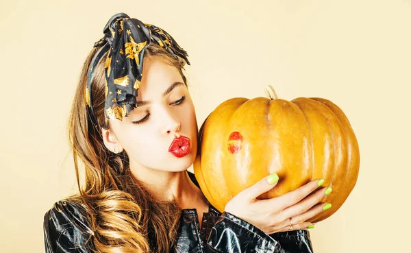 Red lip imprint on halloween pumpkin. Sensual kissing. Lipstick kiss print - beauty girl portrait. Lips pomade imprint on halloween pumpkin. Beautiful lip lipstick and mouth.