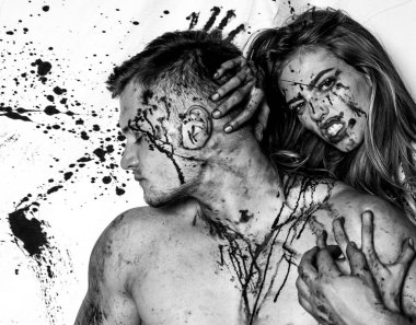 Blood is flowing down the neck, bite marks are visible. Sexy woman vampire bites a mans neck. Woman with red blood and with blond hair. Killer, maniac. Desire, thirst concept.