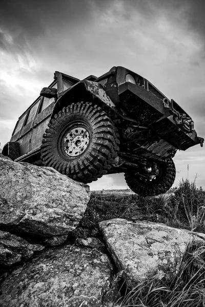 Off-road travel on mountain road. Car tire. Tire for offroad. Offroad vehicle stuck on impenetrable road after rain in the countryside.