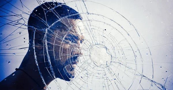 Crack. macho man behind crushed glass. anger. destruction. crush test. theft. emotional discharge. bullet hole in glass. broken glass because of hit. sexy hispanic man broken mirror. crack in glass — Stock Photo, Image