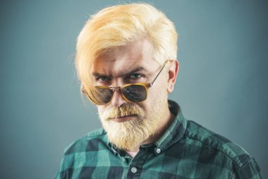 Man. Handsome man with great smile wearing fashion eyeglasses against dark background with copy space.