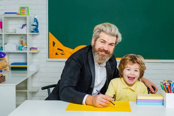 Learning concept. Father and son together schooling. Happy school kids at lesson. Home study. — Stok fotoğraf