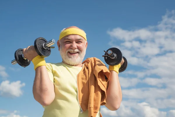 Happy senior man with dumbbell looking at camera. Grandfather exercising with dumbbell. Sport for senior man. — 스톡 사진