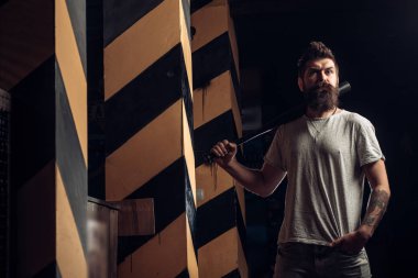 Power and strength. Attack concept. Angry man in T-shirt ready to swing. Sport. Threatening angry man with a beard. Strong temper.