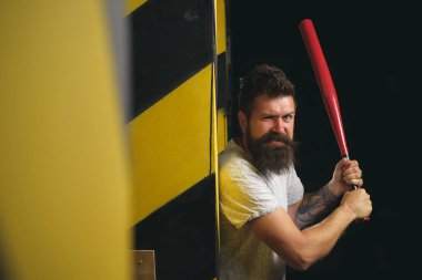 Handsome man hand holds baseball sport bat. Power and energy concept. Bearded man with baseball bat. Gangster with bat weapon.