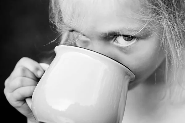 Dziewczyna coś pije. Woda, sok lub mleko. Szczęśliwe chwile. Beztroskie dziecko. — Zdjęcie stockowe