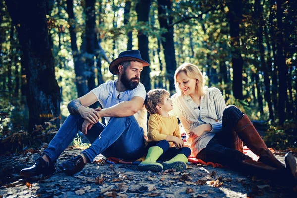 Autumn Family Camping in the Park. Active people and happy family concept. Outdoors. Autumn camping with kids, mom and father.