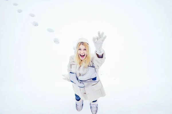 Zabawna twarz. Piękna szczęśliwa śmiejąca się młoda kobieta nosząca zimowe rękawiczki i szalik pokryty płatkami śniegu. Zima kobieta portret odkryty. — Zdjęcie stockowe