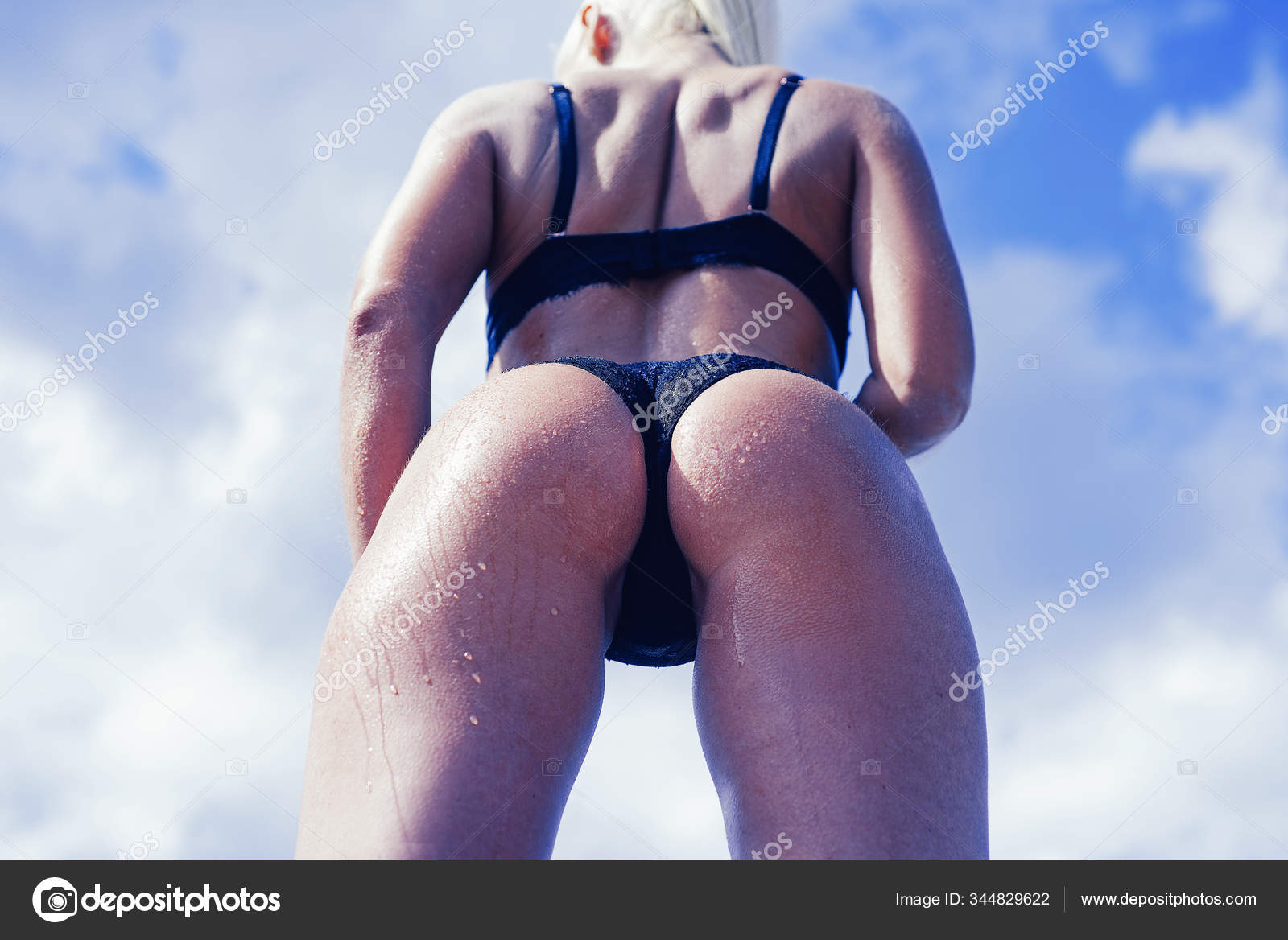 Beautiful tanned woman posing in bikini. Ideal woman anti-cellulite body and skin care. Sexy female ass in luxury panties