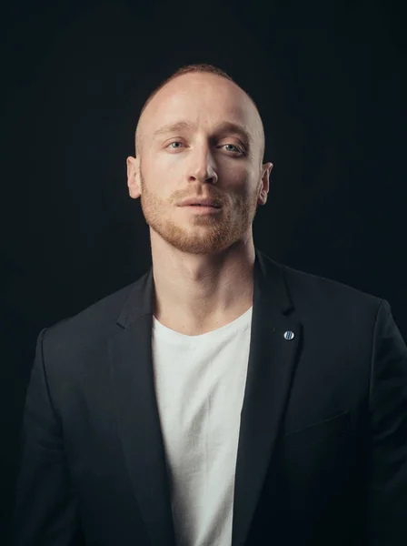 Portrait of thinking man isolated over black background. Portrait of handsome man in studio on dark background. High quality from the raw.