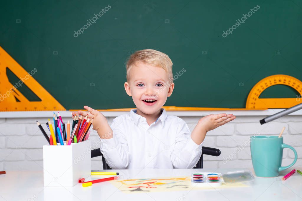 Portrait of Pupil in classroom. Home school for pupil. Home schooling. Back to school. Child near chalkboard in school classroom.
