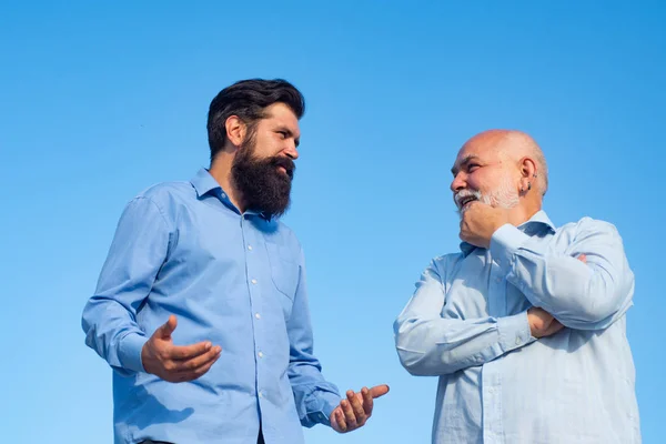 Handsome senior men in blue shirt. Male multi generation family walking. Happy grandfather and father over blue sky and clouds background. Male multi generation family. — Stock Photo, Image