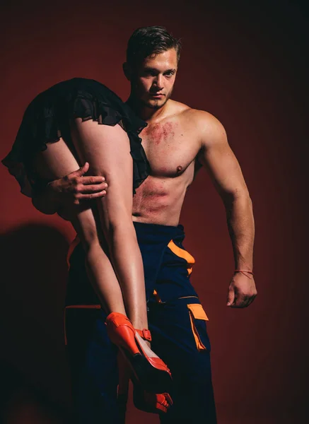 Firefighter sexy body muscle man holding saved sexy woman. Intimate relationship and sexual relations. Hot sexy Firefighter. Superhero. Passion and sensual touch. — Stock Photo, Image