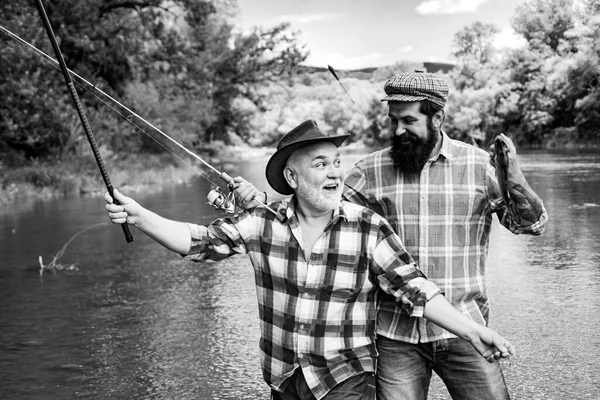 Portrait of cheerful two bearded men fishing. Fishermen fishing equipment. Fly fishing. Fish normally caught in wild. Happy fishermen. Summer weekends or vacation. Real happiness. — Stock Photo, Image