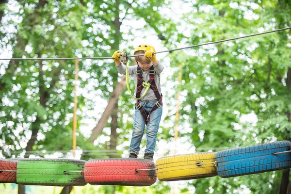 Playground. Child climbing on high rope park. Cute child boy. — Stock Photo, Image