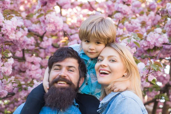 Joyeux famille à l'extérieur. Mère, père et fils. Au printemps. Portrait de famille heureuse en fleurs Jardin . — Photo