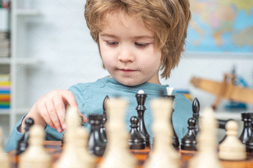 Chess strategy. Kid playing chess. Thinking kid.