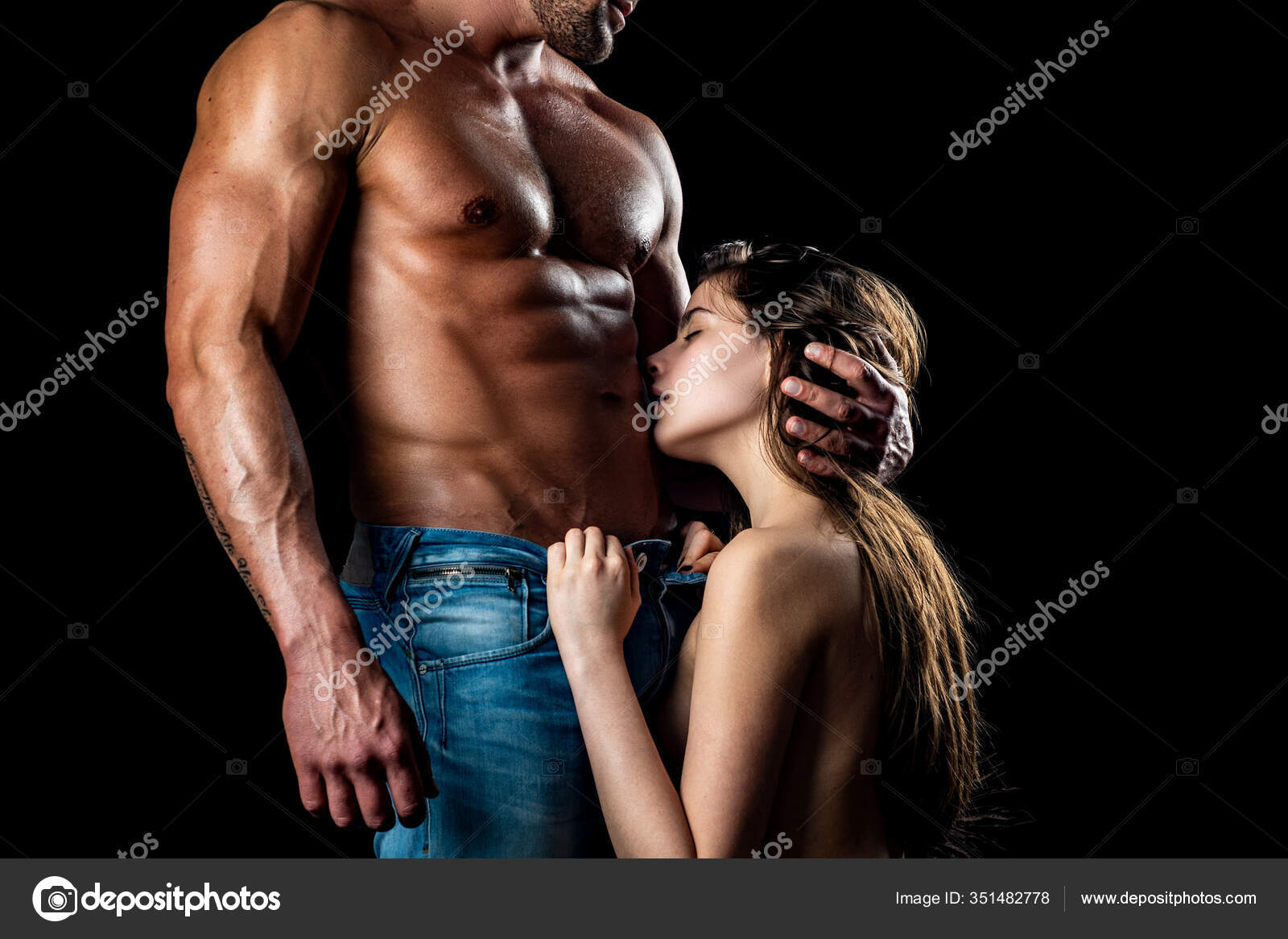 Closeup of undressed sensual pair of young brunette lady embracing and kissing man with beautiful muscular wet body with six-pack and abdoman