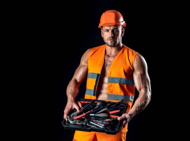Repairman wearing build helmet hold building tools. Professional worker man. clipart