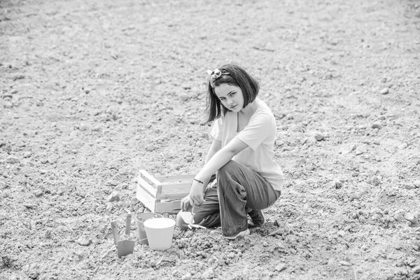 Ένας μικρός βοηθός στον κήπο. Ένα κοριτσάκι που κάνει κηπουρική και διασκεδάζει στην αυλή της άνοιξης. Η κόρη καλλιεργεί λουλούδια. Καλλιέργεια σε αγρούς. — Φωτογραφία Αρχείου