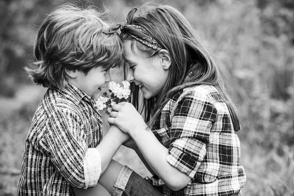 Crianças adoram conceito. A verdadeira história do Dia dos Namorados. Cartões de Dia dos Namorados. Pequenos amigos soprando sementes de dente-de-leão juntos em um parque . — Fotografia de Stock