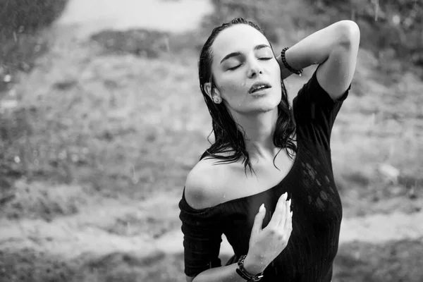 Sexy beautiful young woman enjoying summer rain. Attractive brunette woman wearing black bodysuit and standing under the cold rain. Portrait of sexy wet woman. — 스톡 사진