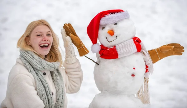 Christmas Girl y muñeco de nieve sobre fondo blanco. Hacer muñeco de nieve y diversión de invierno para niña . — Foto de Stock