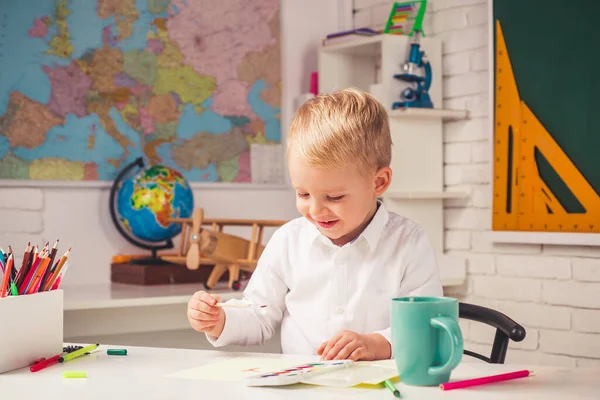 Friendly child in classroom near blackboard desk. Portrait of Pupil in classroom. Individual teaching. Individual tutoring. — Stock Photo, Image