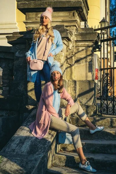 Beauty fashion photo of beautiful blonde and brunette models wearing soft pink and blue flufy jampers, cardigans and hat. Autumn outfits. Dreamy fashion look concept. — Stock Photo, Image