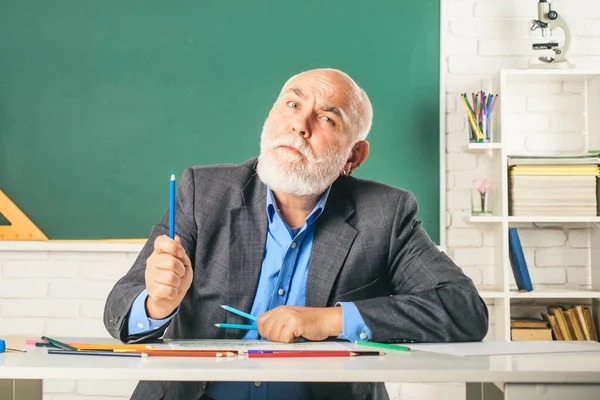 World teachers day. Grandfather teacher. Portrait of funny mature teacher in classroom.