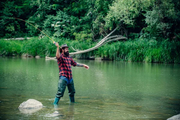 Elegant bearded brutal hipster man fishing. Fish on hook. Catch me if you can. Nice day for fishing. Keep calm and fish on. Fisherman with fishing rod. Handsome fisherman. — Stock Photo, Image