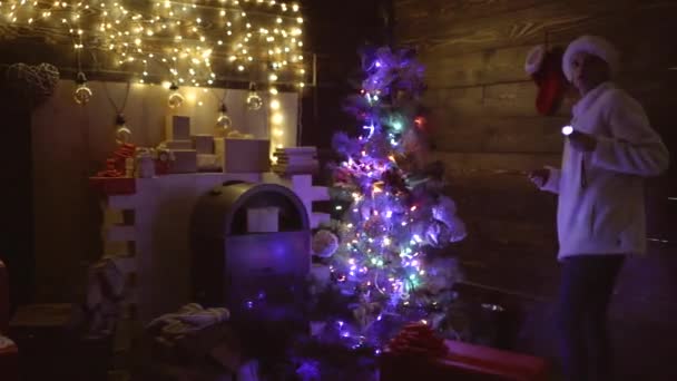 Woman with christmas socks at home. Young woman checking Christmas socks. Mather preparation Christmas socks of the presents at night. Christmas stocking. — Stock Video