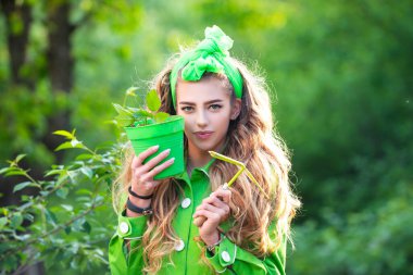 Saksıda bahar çiçekleri olan mutlu bir kadın bahçıvan. Çiçek saksısı olan güzel bahar kızı. Çiçek ekiyorum..