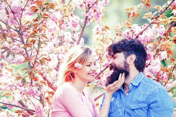 I Love You. Tender love feelings. Loving man and woman on a walk in a spring blooming park. True love. Spring couple laughing and hugging. Happy Valentines Day.