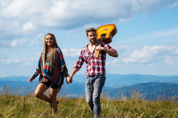 Pareja enamorada en el campamento. Dos amigos hombre y mujer caminando y disfrutando del tiempo todos juntos. Los amigos van al viaje de las montañas. Pareja tomando una excursión en una montaña, caminando . — Foto de Stock