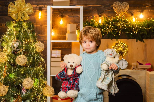 Wish you merry Christmas. Christmas kids. Models child having fun with teddy bear. The morning before Christmas.