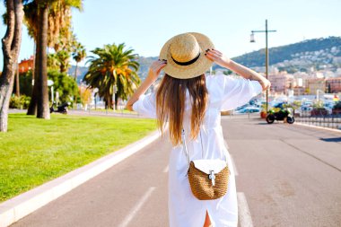 Genç, güzel bir kadın yürüyor, arkadan bakıyor.